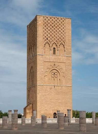The Hassan Tower in Rabat — the unfinished 12th-century Almohad minaret intended to be the tallest in the Islamic world, its red sandstone shaft rising 44 metres above the platform of 300 surviving columns that mark the footprint of what would have been one of the largest mosques ever built